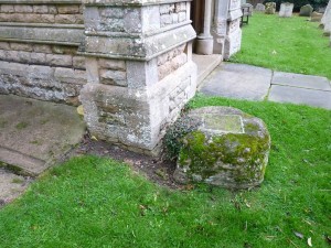 The base of the cross outside the porch of Holme church.